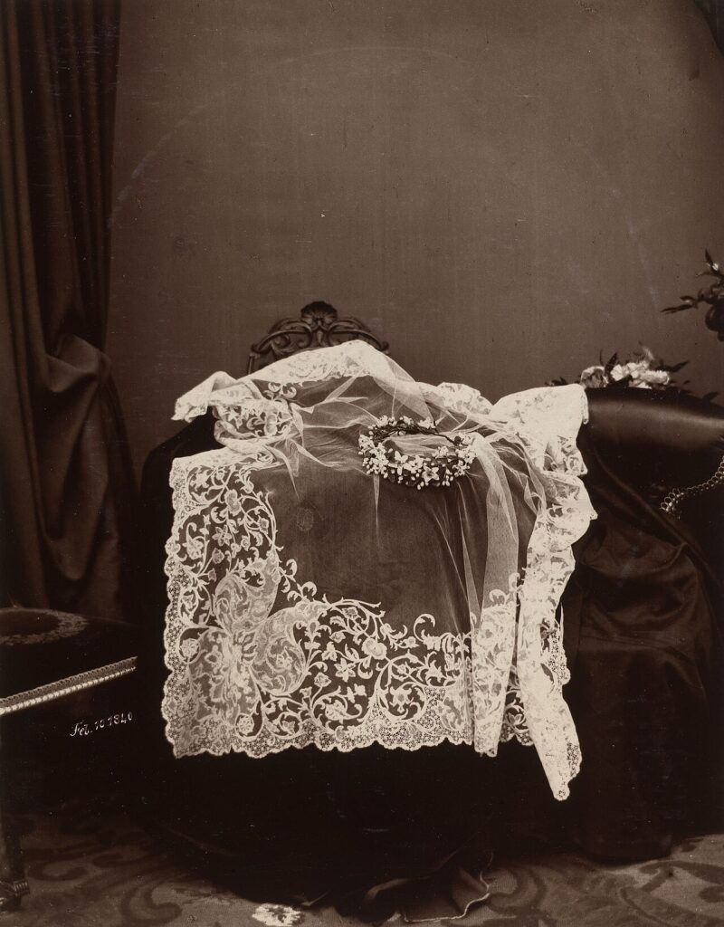An image of a wedding veil draped over a stool showing its intricate and fine lines.